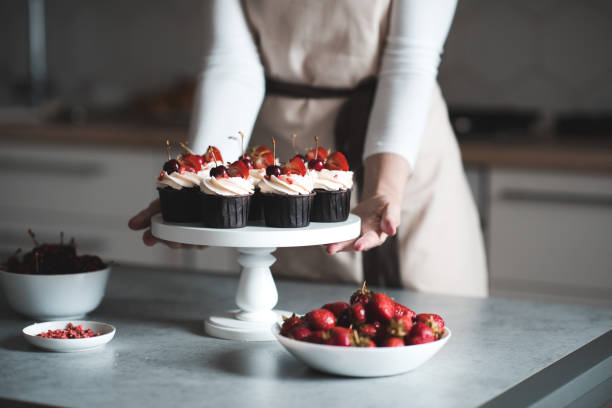 istock Woman cooking cupcakes at home 1256725685