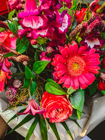 Beautiful pink rose and alstroemeria flowers in a bouquet on soft background