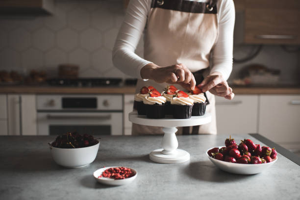 istock Woman cooking cupcakes at home 1256725903