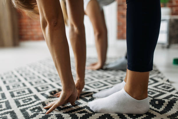 istock Two girlfriends exercising together at home 1256727864
