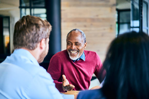 istock Manager laughing during a meeting with his team in an office 1256730552