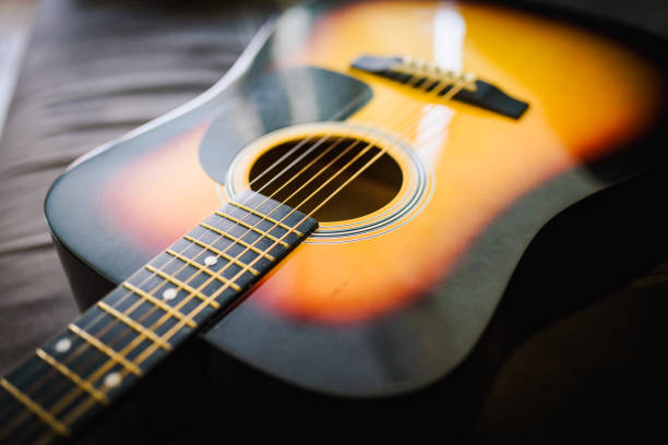 istock Close up of a guitar with a reflection from a window 1256732153