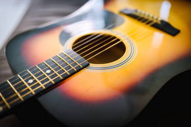 istock Close up of a guitar with a reflection from a window 1256732154