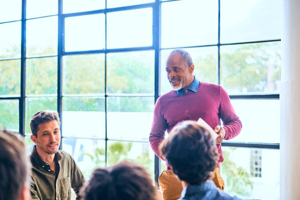 istock Smiling manager talking with his diverse team during a meeting 1256732329