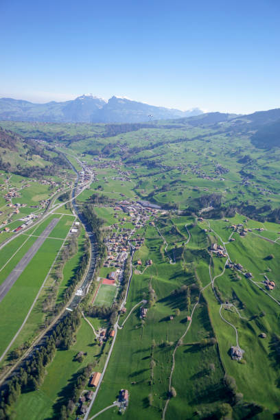 istock Wing suit soars above mountain landscape 1256732350