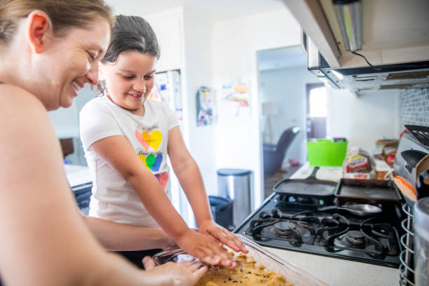 istock Beautiful Mother Baking with her Young Daughters 1256732934