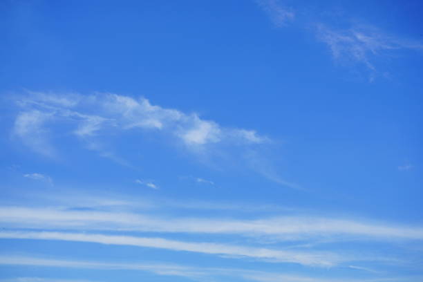 istock Fluffy soft sky white clouds in the clear blue sky 1256734734