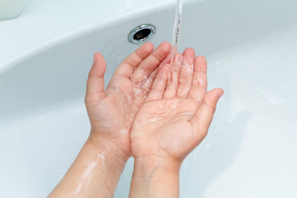 istock small kid, child washes his hands under the tap in the sink 1256734794