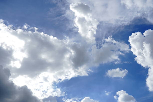 istock Fluffy soft sky white clouds in the clear blue sky 1256734871