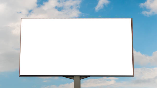 istock Mock up image - blank white billboard and white clouds against blue sky 1256737856