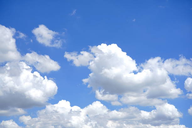 istock Fluffy soft sky white clouds in the clear blue sky 1256739349
