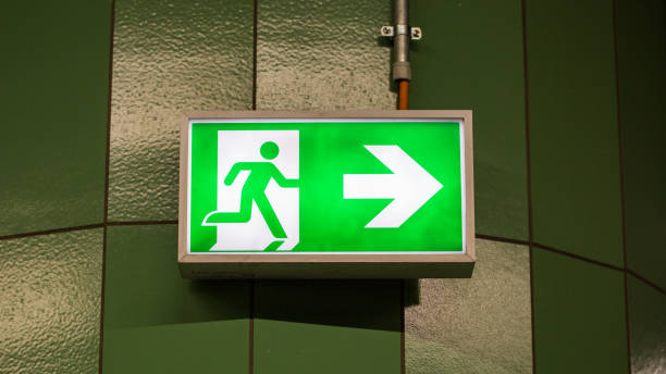 istock Close up of illuminated emergency exit sign 1256739720