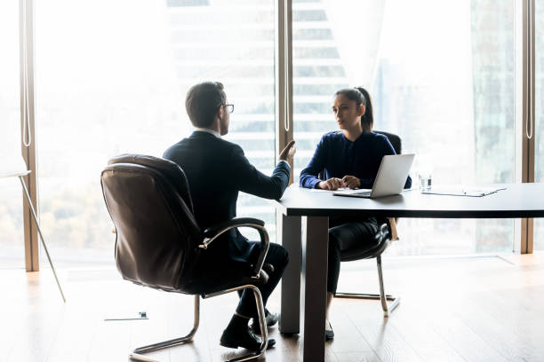istock Two focused successful business people having serious talk. 1256739918
