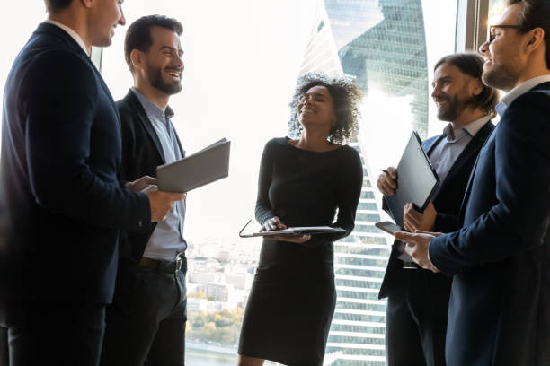 Overjoyed group of diverse employees having fun in modern office.