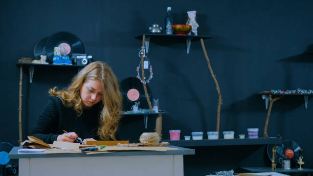 istock Professional woman decorator, designer working with kraft paper 1256741034