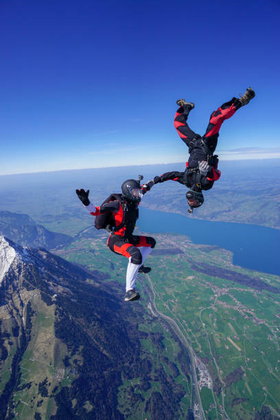 istock Freefall jumpers soar above mountain landscape 1256742397