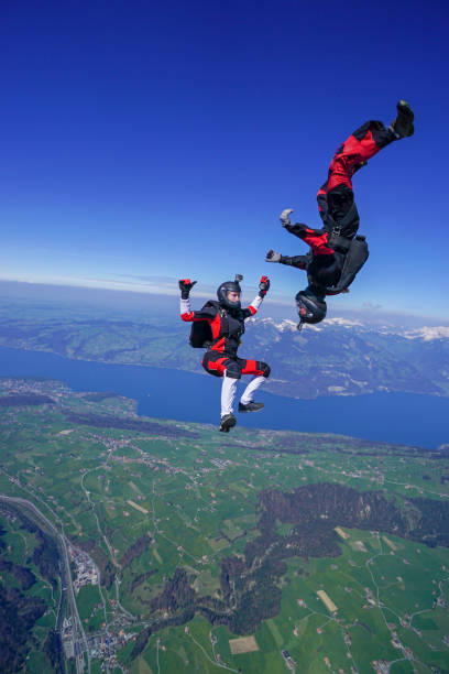 istock Freefall jumpers soar above mountain landscape 1256743034