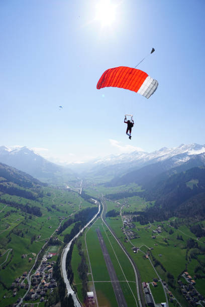 istock Parasailer soars above mountain landscape 1256743339