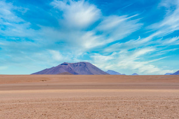 The image features a mountain landscape during sunset with mostly clear skies. The natural beauty of the mountains and the sky is the focus; there are no people or man-made elements present. The scene is set in a mountainous area, showcasing a wide and natural landscape.