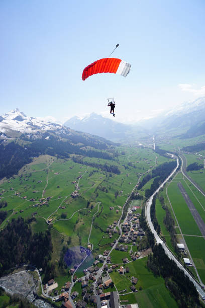 istock Parasailer soars above mountain landscape 1256743536