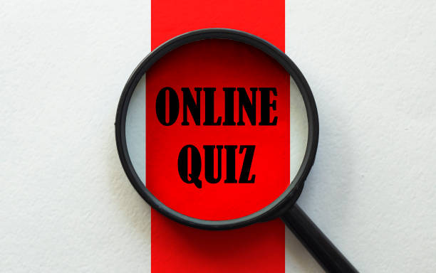 istock magnifier with text Online Quiz on the white and red background 1256744668