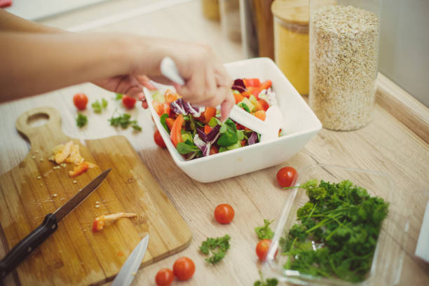 istock The girl is preparing a salad for lunch 1256744761