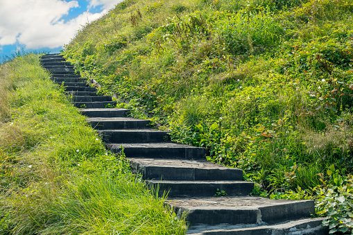 A stairway that leads up a hillside.