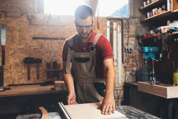 istock Carpenter Cutting Wood on a Table Saw, Small Business Concept 1256745936