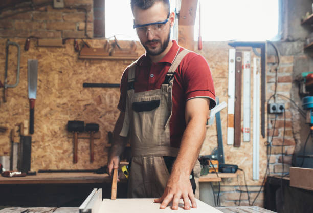 istock Carpenter Cutting Wood on a Table Saw, Small Business Concept 1256745955