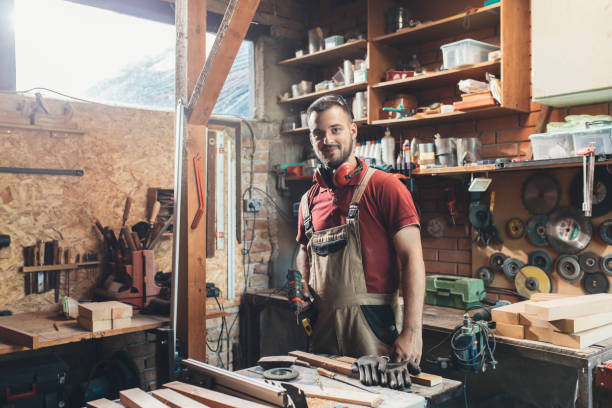 istock Portrait of a Happy Carpenter Standing in his Workshop, Looking at Camera 1256745965