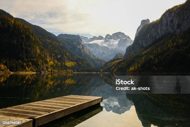Scenic View Of Lake Gossau With A Pier And Dachstein Glacier In The Background Stock Photo - Download Image Now