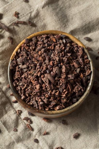 Raw Brown Organic Chocolate Cocao Nibs Raw Brown Organic Chocolate Cocao Nibs in a Bowl cacao nib stock pictures, royalty-free photos & images