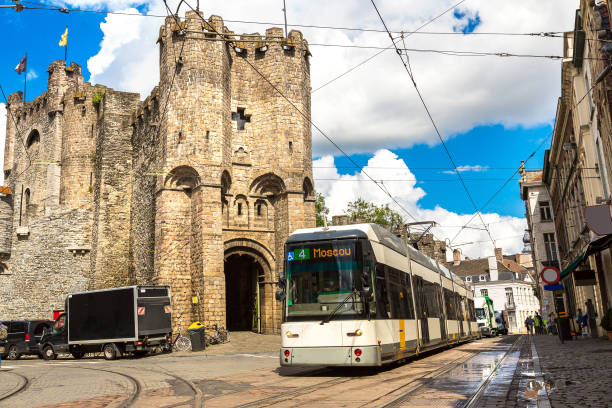 city tram in gent in a beautiful summer day, belgium - castle gravensteen imagens e fotografias de stock