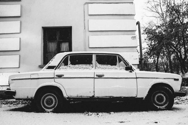 The white old car under a snow