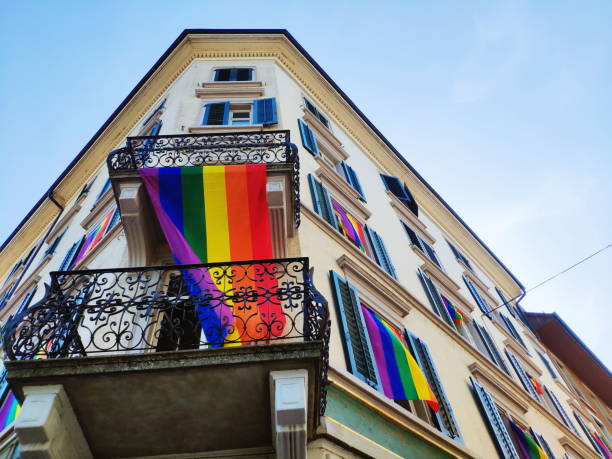 istock Rainbow flag hanging on building under the window 1256753481
