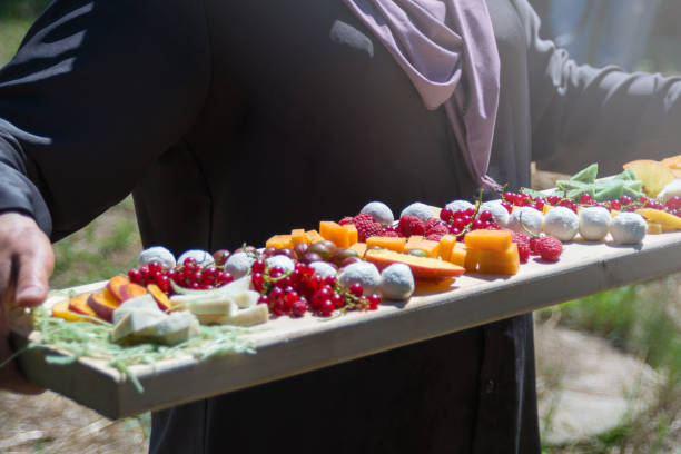 istock Raspberry berries among organic goat cheese in a craft cheese factory. 1256754403