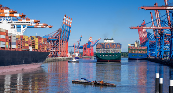 Three container ships in the harbour of Hamburg, Germany.