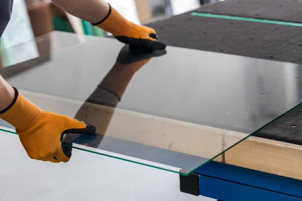 glass factory, glazier lifting that table glass - vidro imagens e fotografias de stock