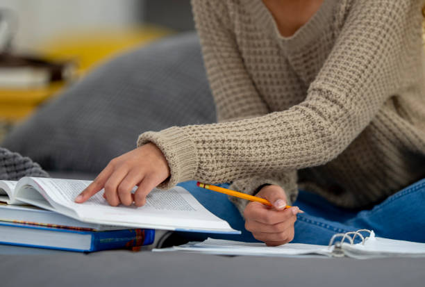 istock Teenage girl does school work from home 1256756629