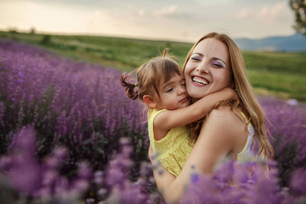 istock Mother with daughter in a lavender field 1256757299