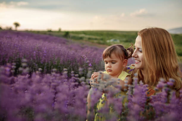 istock Mother with daughter in a lavender field 1256757319