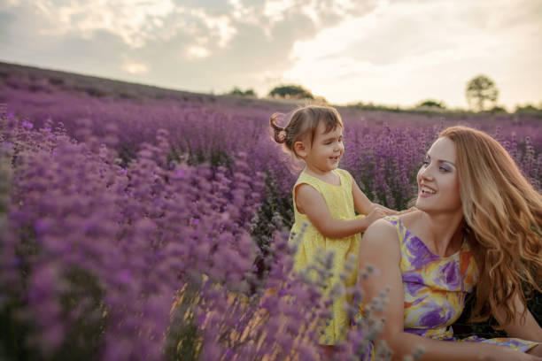 istock Mother with daughter in a lavender field 1256757333