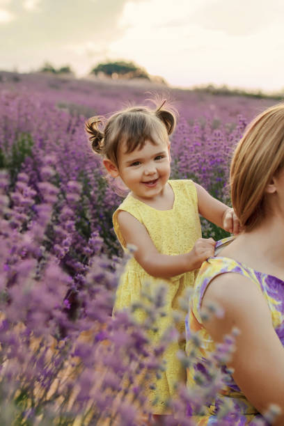 istock Daughter with mother in a lavender field 1256757401
