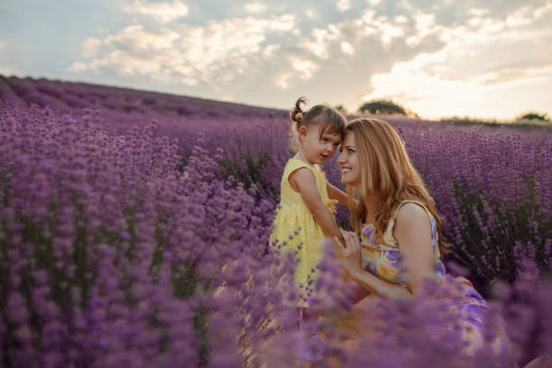 istock Mother with daughter in a lavender field 1256757422