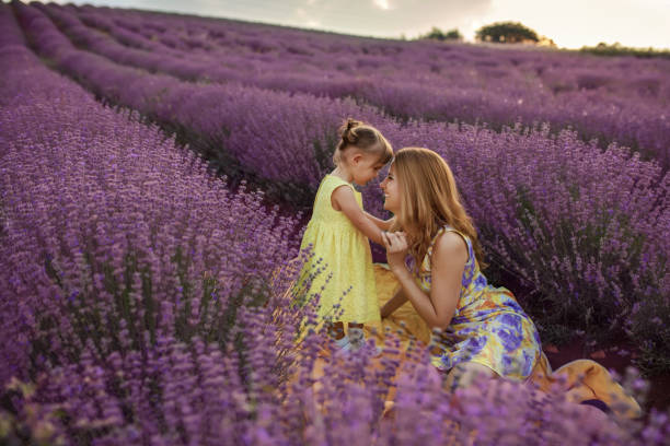 istock Mother with daughter in a lavender field 1256757424