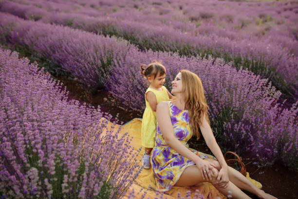 istock Mother with daughter in a lavender field 1256757450