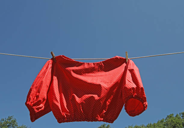 istock Red polka dot summer blouse on the rope. 1256757466
