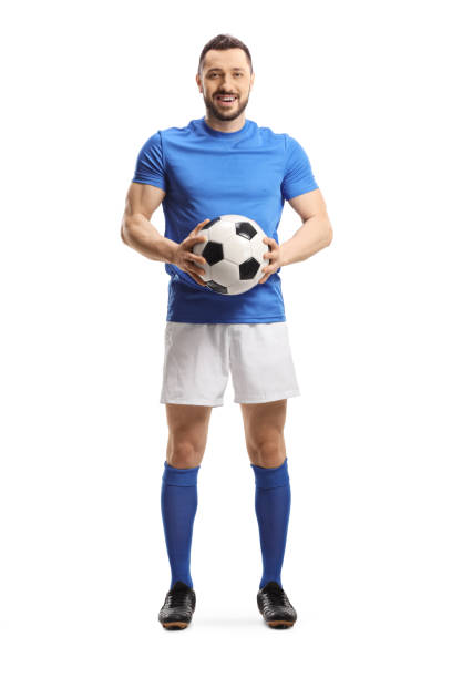 istock Soccer player holding a ball and looking at the camera 1256757618