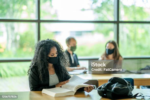 Small Group Of Mixed Ethnicity Students Wearing Masks In A Classroom Stock Photo - Download Image Now