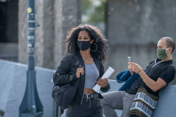 istock African American student walking to class wearing a protective face mask 1256757871
